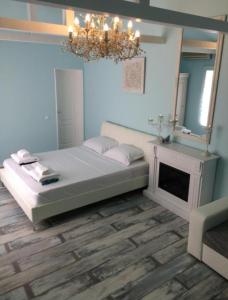 a bedroom with a bed with a mirror and a chandelier at Solaria House in Constanţa