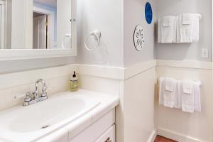a white bathroom with a sink and a mirror at Berni's Ocean View Castle - Home Sweet Homestead in Oceanside +30 photos