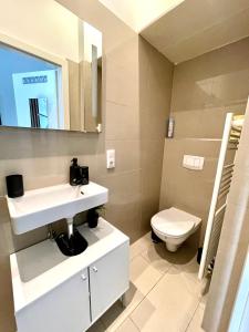a bathroom with a sink and a toilet at My city apartment - Vienna CityRoom in Vienna