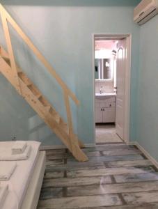 a bathroom with a staircase in a room at Solaria House in Constanţa