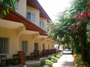 a row of tables and chairs next to a building at Dalyan Pension in Dalyan
