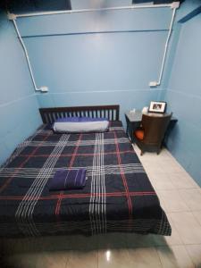 a bedroom with a bed and a table with a chair at Sura Hostel and Coworking in Bangkok