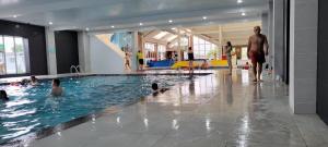 a group of people swimming in a swimming pool at Sailor's Corner in Prestatyn