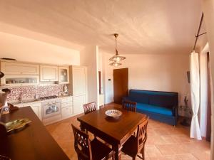 a living room with a table and a blue couch at MEDUSA apartment Baja Sardinia in Cala Bitta