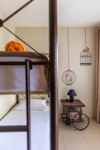 a bedroom with a bunk bed and a table with a lamp at Ionias Apartment in Heraklion in Heraklio