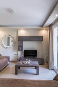 a living room with a couch and a table at Ionias Apartment in Heraklion in Heraklio