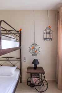 a bedroom with a bed and two hanging cages at Ionias Apartment in Heraklion in Heraklio
