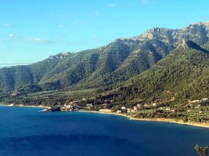 a view of a mountain range with a body of water at Blue Bay Beach Hotel in Koinyra