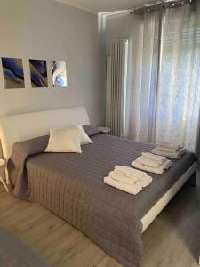 1 dormitorio con 1 cama grande y toallas. en Casavacanzalacorte, en Cadrezzate