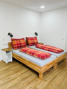 a bed with two pillows on it in a room at Wohnen an der Vöckla in Vöcklamarkt