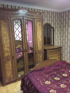 a bedroom with a bed and a dresser and window at ARTDELUXE in Artashat