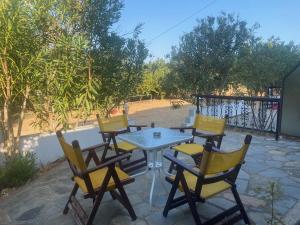 a table and chairs sitting on a patio at Blue Bay Beach Hotel in Koinyra