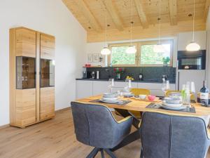 a kitchen and dining room with a wooden table and chairs at samerbergzeit in Samerberg