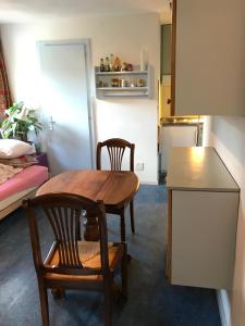 a kitchen with a wooden table and two chairs at Super studio à Grimentz in Grimentz