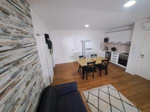 een woonkamer met een tafel en stoelen en een keuken bij Beach House 2 in Espinho