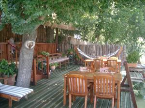 a deck with a table and chairs and a hammock at Dalyan Pension in Dalyan