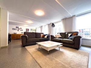 a living room with two couches and a coffee table at Au Grand Pierrot in Spa