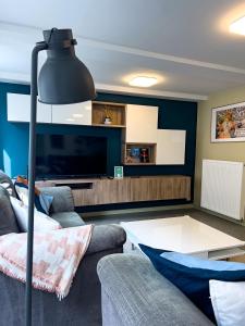 a living room with a couch and a table at Au Grand Pierrot in Spa