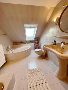 a bathroom with a tub and a sink and a toilet at Dein zweites Zuhause in Hannover an der Messe in Hannover +17 photos