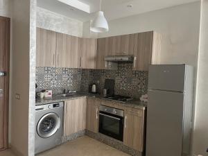 a kitchen with a refrigerator and a washing machine at Super studio confortable in Casablanca