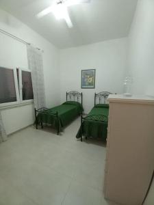 Zimmer mit 2 grünen Betten in der Unterkunft Villa Luce - S.Maria al Bagno - Mare del Salento in Santa Maria al Bagno