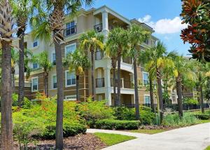 a large building with palm trees in front of it at Universal Studios Area Apartment in Orlando