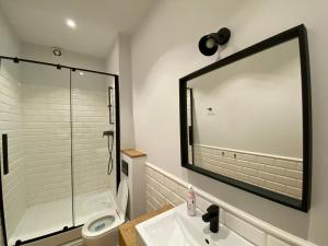 a bathroom with a shower and a sink and a mirror at Cozy Flat in Rynek in Wrocław