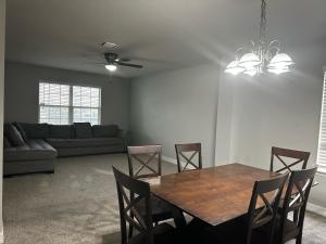 a living room with a table and chairs and a couch at Fresh CrashPads in Houston