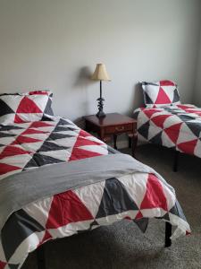 a bedroom with two beds and a table with a lamp at Fresh CrashPads in Houston
