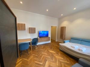 a room with a bed and a desk and a tv at Cozy Flat in Rynek in Wrocław