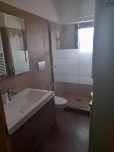 a bathroom with a sink and a toilet and a shower at Villetta da Fedro in Leporano