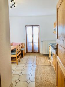a room with a kitchen with a table and a window at Haus Gerda Ferienwohnung 2 in Arnbruck