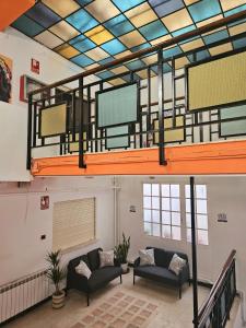 a large room with two couches and a balcony at Arc House Granada in Granada