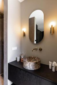 a bathroom with a sink and a mirror at The Mini Villa in Alkmaar