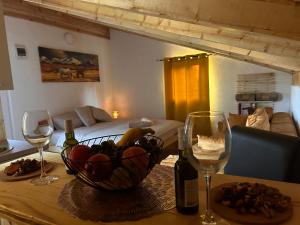 a table with a bowl of fruit and wine glasses at Apartments Javorje Zabljak in Žabljak +43 photos