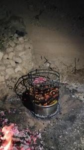 a grill with a bunch of donuts on it at Grandpa House in Wadi Musa