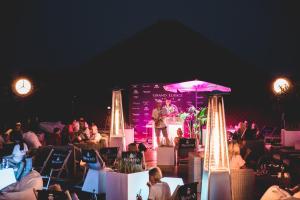 a man standing on a stage in front of a crowd at Grand Lubicz Uzdrowisko Ustka in Ustka