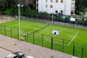 a tennis court with two nets on a grass field at Grand Lubicz Uzdrowisko Ustka in Ustka