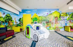 a childrens room with a cartoon mural on the wall at Grand Lubicz Uzdrowisko Ustka in Ustka
