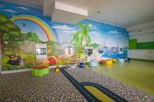 a childrens room with a rainbow mural on the wall at Grand Lubicz Uzdrowisko Ustka in Ustka