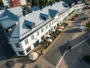 an overhead view of a white building with blue roofs at Hotell Drottninggatan 11 in Boden