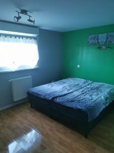 a bedroom with a bed with a blue ceiling at Chez Raphaël in Marckolsheim