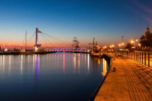 a view of a river at night with a bridge at Grand Lubicz Uzdrowisko Ustka in Ustka