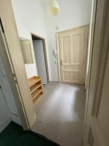 an empty room with a door and a hallway at Volkstheater Apartment. in Vienna