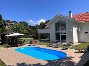 a swimming pool in the backyard of a house at Villa EMIR in Sarajevo