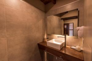 a bathroom with a sink and a mirror at Posada Mawida in Maipú