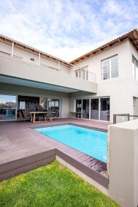 a swimming pool in the backyard of a house at Sunset Golf Villa in Langebaan