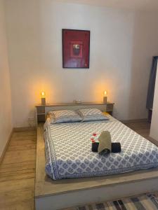 a bedroom with a bed with a hat on it at Chez Berthe in Arles
