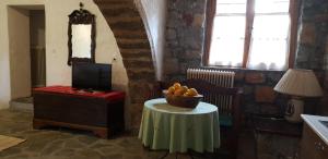 a room with a table with a bowl of fruit on it at Vilaeti Estia in Agios Konstantinos