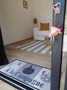 a living room with a rug on the floor at Studio Les petites poules in Saint-Lyphard